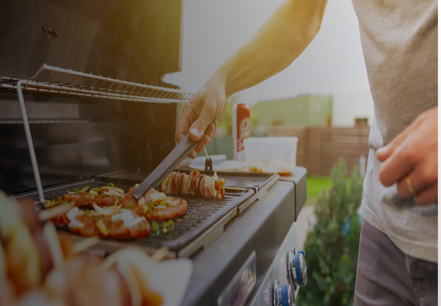 Closeup of a person moving food on an outdoor grill